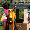 Child playing with playset