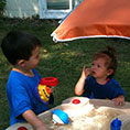 Two children playing with water playset