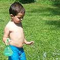 Child playing with squirt bottles